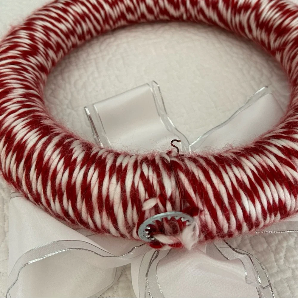 Red & white Candycane style Wreath. White bow accent. Approx 12”. Ready to hang.